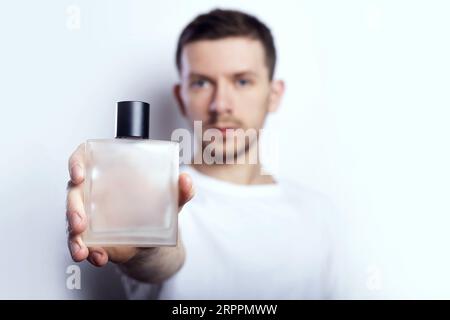 Men's perfume. Man holds perfume Stock Photo - Alamy