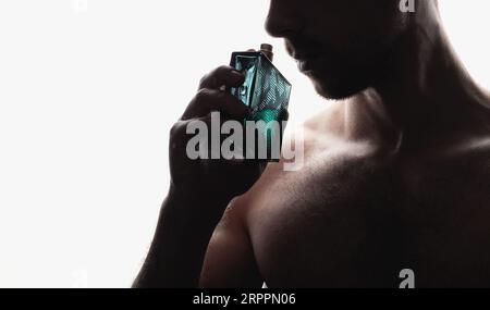 Men's perfume. Man holds perfume Stock Photo