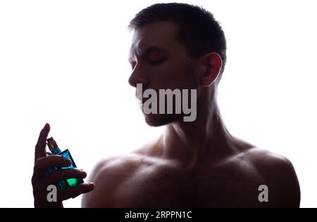 Men's perfume. Man holds perfume Stock Photo