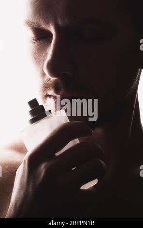 Men's perfume. Man holds perfume Stock Photo