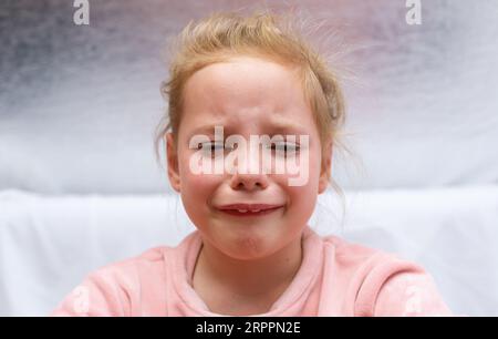 Dramatic photo of a crying kid Stock Photo