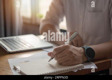 Hands Writing with Pen on Notebook. concept of work, study, and education. Stock Photo