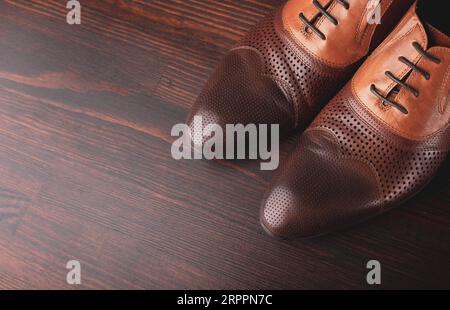 Men shoes on brown wooden background Stock Photo