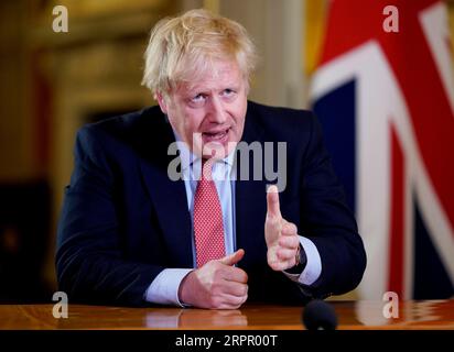 Bilder des Jahres 2020, News 03 März News Themen der Woche KW13 News Bilder des Tages 200323 -- LONDON, March 23, 2020 Xinhua -- British Prime Minister Boris Johnson addresses the nation at 10 Downing Street in London, Britain, on March 23, 2020. British Prime Minister Boris Johnson announced Monday evening a series of measures that aim to restrict social contact in the UK, so as to curb the spread of COVID-19. Andrew Parsons/No 10 Downing Street/Handout via Xinhua EDITORIAL USE ONLY BRITAIN-LONDON-PM-COVID-19-ADDRESS PUBLICATIONxNOTxINxCHN Stock Photo