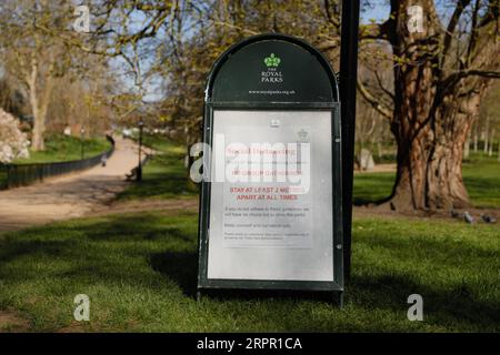 200324 -- LONDON, March 24, 2020 -- A sign encouraging social distancing is seen in Hyde Park after the British government placed further restrictions on movement in London, Britain on March 24, 2020. British Prime Minister Boris Johnson announced Monday evening a series of measures that aim to restrict social contact in the UK, so as to curb the spread of COVID-19. Starting from Monday night, people in Britain will only be allowed to leave their homes for very limited purposes , including shopping for basic necessities, for any medical need, for one form of exercise a day, and to travel to an Stock Photo