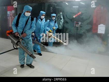 200327 -- WUHAN, March 27, 2020 -- Staff members disinfect a shopping mall at the Hanzheng Street in Wuhan, central China s Hubei Province, March 27, 2020. The shopping mall was thoroughly cleaned and disinfected before resumption of business.  CHINA-HUBEI-WUHAN-SHOPPING MALL-DISINFECTION CN WangxYuguo PUBLICATIONxNOTxINxCHN Stock Photo