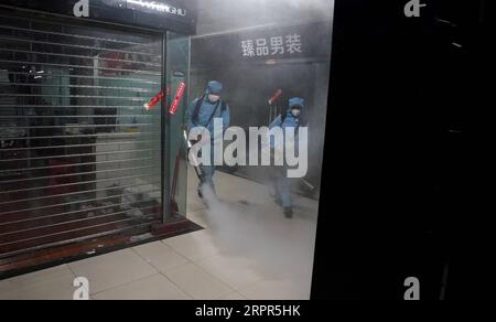 200327 -- WUHAN, March 27, 2020 -- Staff members disinfect a shopping mall at the Hanzheng Street in Wuhan, central China s Hubei Province, March 27, 2020. The shopping mall was thoroughly cleaned and disinfected before resumption of business.  CHINA-HUBEI-WUHAN-SHOPPING MALL-DISINFECTION CN WangxYuguo PUBLICATIONxNOTxINxCHN Stock Photo