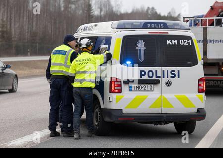 200328 -- HELSINKI, March 28, 2020 Xinhua -- Police officers and a road worker prepare for the blockade on a road in Hyvinkaa, on the northern edge of the Uusimaa region in Finland, March 27, 2020. To prevent the further spread of the coronavirus, the Finnish government on Wednesday launched a plan to block the country s hardest-hit Uusimaa region, which includes the capital Helsinki. The lockdown was expected to start on Friday night under police supervision. Photo by Matti Matikainen/Xinhua FINLAND-HYVINKAA-LOCKDOWN PUBLICATIONxNOTxINxCHN Stock Photo