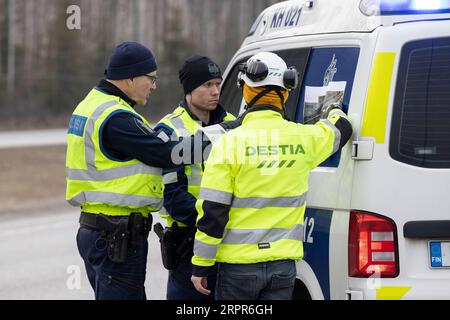 200328 -- HELSINKI, March 28, 2020 Xinhua -- Police officers and a road worker prepare for the blockade on a road in Hyvinkaa, on the northern edge of the Uusimaa region in Finland, March 27, 2020. To prevent the further spread of the coronavirus, the Finnish government on Wednesday launched a plan to block the country s hardest-hit Uusimaa region, which includes the capital Helsinki. The lockdown was expected to start on Friday night under police supervision. Photo by Matti Matikainen/Xinhua FINLAND-HYVINKAA-LOCKDOWN PUBLICATIONxNOTxINxCHN Stock Photo