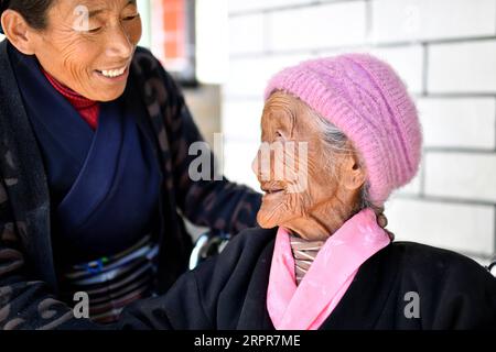 200328 -- LHASA, March 28, 2020 -- Sonam Drolma R talks with her daughter Tsering Dzongpa in Reguo Village of Gyaca County in Shannan, southwest China s Tibet Autonomous Region, March 24, 2020. Saturday marks the Serfs Emancipation Day. Sixty-one years ago, more than one million people, or 90 percent of the region s population of that time, were liberated from the feudal serfdom. Sonam Drolma is a 109-year-old villager in Reguo Village of Shannan. Since she was born, she has gone through half a century of twists and turns and sufferings as a serf. As a descendant of serfs, Sonam Drolma began t Stock Photo