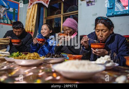 200328 -- LHASA, March 28, 2020 -- Sonam Drolma and her family have a meal in Reguo Village of Gyaca County in Shannan, southwest China s Tibet Autonomous Region, March 24, 2020. Saturday marks the Serfs Emancipation Day. Sixty-one years ago, more than one million people, or 90 percent of the region s population of that time, were liberated from the feudal serfdom. Sonam Drolma is a 109-year-old villager in Reguo Village of Shannan. Since she was born, she has gone through half a century of twists and turns and sufferings as a serf. As a descendant of serfs, Sonam Drolma began to work for serf Stock Photo