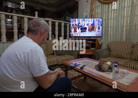 200330 -- BETHLEHEM, March 30, 2020 Xinhua -- A Palestinian watches a live TV broadcast of Sunday Mass from an Orthodox church in Beit Sahour near the West Bank city of Bethlehem on March 29, 2020. For the first time ever, Raed al-Atrash, a 54-year-old Palestinian man from the West Bank city of Bethlehem, attended the Sunday Mass with his family through a live TV broadcast, as the churches are closed as part of the precautions against the spread of the novel coronavirus. TO GO WITH Feature: Christians in Palestine attend live prayers as churches close over coronavirus fears Photo by Luay Sabab Stock Photo