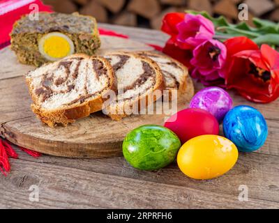 lamb tripe meat cake, sponge cake and colored easter eggs on table Stock Photo