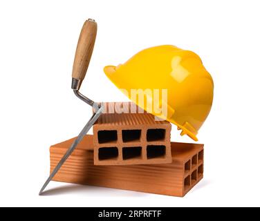 Trowel  bricks and hardhat isolated on white background Stock Photo