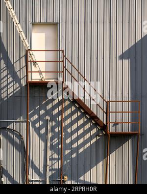 Shadows from fire escape stairs Stock Photo