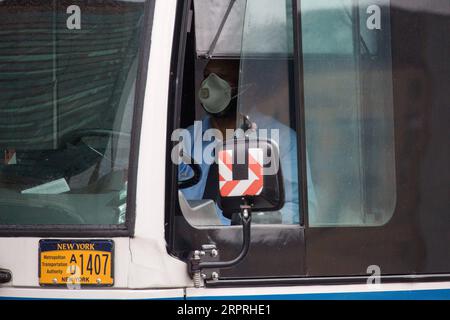 200404 -- NEW YORK, April 4, 2020 Xinhua -- A bus driver wearing a face mask steers in the Brooklyn borough of New York, the United States, on April 3, 2020. U.S. President Donald Trump said on Friday the Centers for Disease Control and Prevention CDC now recommends that Americans wear cloth face coverings to protect against COVID-19. The CDC is advising the use of non-medical cloth face covering as a voluntary health measure, Trump told a White House briefing. It is voluntary. They suggested for a period of time. Photo by Michael Nagle/Xinhua U.S.-NEW YORK-COVID-19-CLOTH FACE COVERING PUBLICA Stock Photo