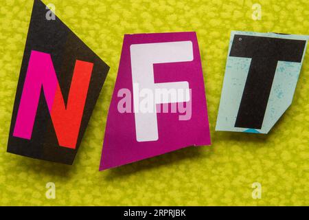 The acronym 'NFT'  (Non-Fungible Token) using cut-out paper letters in the ransom note effect typography, USA Stock Photo