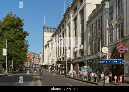 Kensington High Street, London UK, in summertime, with Kensington Tube station and shoppers Stock Photo