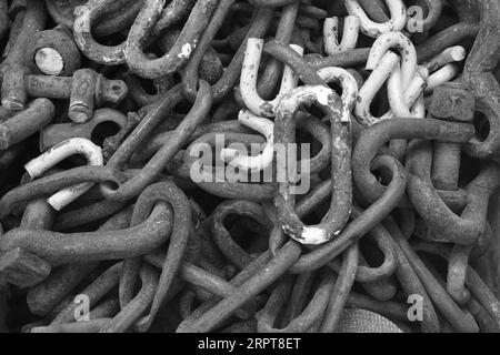 Background and graphic resources. Black and white image of a pile of large industrial metal grappling hooks and irons used in by commercial trawlers Stock Photo