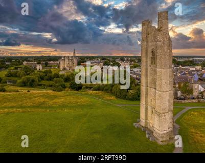 Aerial view of Trim castle, town and St Mary's Abbey ruined Gothic church tower with dramatic sunset sky in Ireland Stock Photo