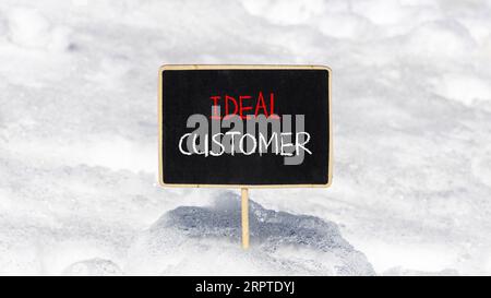 Ideal customer symbol. Concept words Ideal customer on beautiful black chalk blackboard. Chalkboard. Beautiful snow background. Business ideal custome Stock Photo