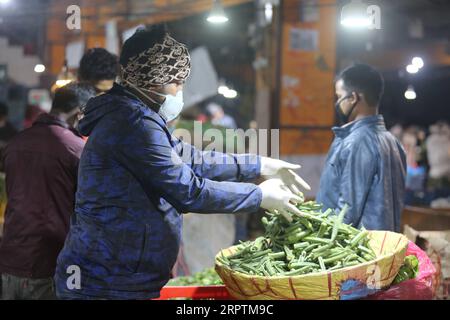 200416 -- KATHMANDU, April 16, 2020 -- A vendor sorts vegetable at Kalimati vegetable market in Kathmandu, Nepal, April 16, 2020. The market opens at 2 to 5 a.m. during lockdown amid the COVID-19 outbreak in Kathmandu.  NEPAL-KATHMANDU-COVID-19 ZhouxShengping PUBLICATIONxNOTxINxCHN Stock Photo