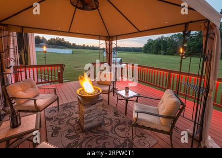 Fire pit on outdoor backyard covered deck, Pennsylvania, USA Stock Photo