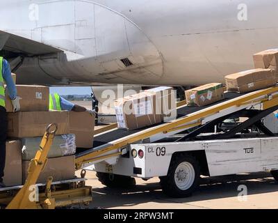 200421 -- HARARE, April 21, 2020 Xinhua -- A charter flight unloads medical supplies and equipment after landing at Robert Gabriel Mugabe International Airport in Harare, Zimbabwe, April 20, 2020. Zimbabwe on Monday took delivery of a huge consignment of medical supplies and equipment sourced from China for use in the ongoing fight against the coronavirus pandemic. Photo by Zhou Xuegong/Xinhua ZIMBABWE-HARARE-MEDICAL SUPPLIES PUBLICATIONxNOTxINxCHN Stock Photo