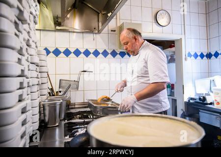 200425 -- ROSENHEIM, April 25, 2020 Xinhua -- Michael Haldek, one of the owners of restaurant Fischkueche, prepares free meals in the kitchen of the restaurant in Rosenheim, southern Germany, April 24, 2020. As the COVID-19 hit southern German city Rosenheim, Fischkueche Fish Kitchen, a restaurant with a history of more than 100 years, has provided nearly 2,000 free meals with free delivery by volunteers to local people needing help in recent five weeks. Photo by Kevin Voigt/Xinhua GERMANY-ROSENHEIM-COVID-19-FREE MEALS PUBLICATIONxNOTxINxCHN Stock Photo