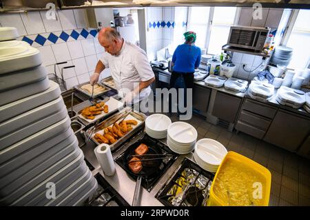 200425 -- ROSENHEIM, April 25, 2020 Xinhua -- Michael Haldek L and Christine Haldek, owners of restaurant Fischkueche, prepare free meals in the kitchen of the restaurant in Rosenheim, southern Germany, April 24, 2020. As the COVID-19 hit southern German city Rosenheim, Fischkueche Fish Kitchen, a restaurant with a history of more than 100 years, has provided nearly 2,000 free meals with free delivery by volunteers to local people needing help in recent five weeks. Photo by Kevin Voigt/Xinhua GERMANY-ROSENHEIM-COVID-19-FREE MEALS PUBLICATIONxNOTxINxCHN Stock Photo