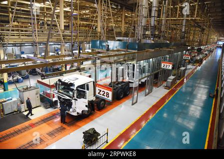 200428 -- JINAN, April 28, 2020 -- Employees work at an assembly line of China National Heavy Duty Truck Group Co., Ltd. in Jinan, capital of east China s Shandong Province, April 28, 2020. The leading heavy-duty truck maker of China has made timely adjustment of the supply chain after the outbreak of COVID-19, which enabled it to seize the opportunity of market recovery. At present, it has received orders of more than 40,000 trucks.  CHINA-SHANDONG-HEAVY-DUTY TRUCKS-PRODUCTION-RESUMPTIONCN WangxKai PUBLICATIONxNOTxINxCHN Stock Photo