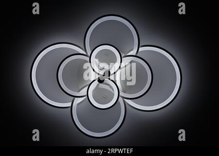 Luminous modern LED ring lamp on the ceiling. Bottom view. Stock Photo