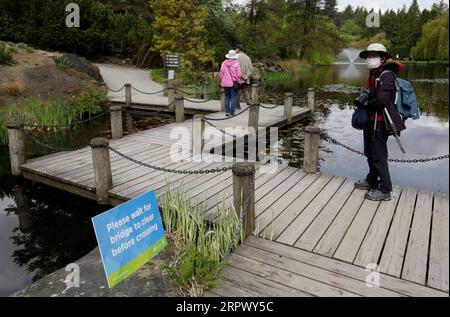 200501 -- VANCOUVER, May 1, 2020 Xinhua -- A visitor follows the sign instruction by waiting the bridge to be cleared before crossing it at the reopened VanDusen Botanical Garden in Vancouver, Canada, on May 1, 2020. Vancouver started on Friday to gradually reopen public recreation facilities with safety measures amid COVID-9 pandemic. Photo by Liang Sen/Xinhua CANADA-VANCOUVER-COVID-19-RECREATION FACILITIES-REOPENING PUBLICATIONxNOTxINxCHN Stock Photo