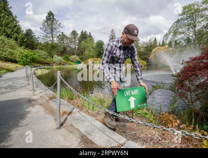 200501 -- VANCOUVER, May 1, 2020 Xinhua -- A staff member puts a one-way sign at the reopened VanDusen Botanical Garden in Vancouver, Canada, on May 1, 2020. Vancouver started on Friday to gradually reopen public recreation facilities with safety measures amid COVID-9 pandemic. Photo by Liang Sen/Xinhua CANADA-VANCOUVER-COVID-19-RECREATION FACILITIES-REOPENING PUBLICATIONxNOTxINxCHN Stock Photo