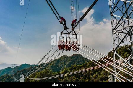 200502 -- HANZHONG, May 2, 2020 -- Aerial photo taken on May 1, 2020 shows electricians working at the construction site of an ultra-high voltage UHV direct-current DC transmission line in northwest China s Shaanxi Province. Nearly 10,000 electricians from across the country are building the Shaanxi section of the 800-kv UHV DC transmission line between northwest China s Qinghai Province and central China s Henan Province.  CHINA-SHAANXI-TRANSMISSION LINE-CONSTRUCTION CN TaoxMing PUBLICATIONxNOTxINxCHN Stock Photo