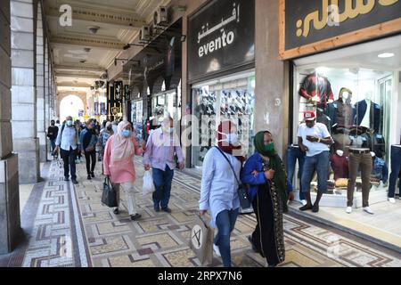 200512 -- TUNIS, May 12, 2020 Xinhua -- People walk past stores in Tunis, Tunisia, on May 11, 2020. Amid the improvement of the situation, Tunisia started on May 4 partial lifting of the lockdown, which includes three stages, from May 4 to 24, from May 24 to June 4, and from June 4 to 14. Photo by Adel Ezzine/Xinhua TUNISIA-TUNIS-COVID 19-LOCKDOWN-PARTIAL LIFTING PUBLICATIONxNOTxINxCHN Stock Photo