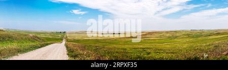 Panorama view; rural dirt road; Badlands National Park; South Dakota; USA Stock Photo