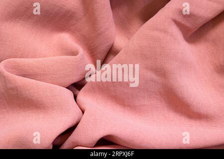 background and texture of pink cotton fabric with folds Stock Photo