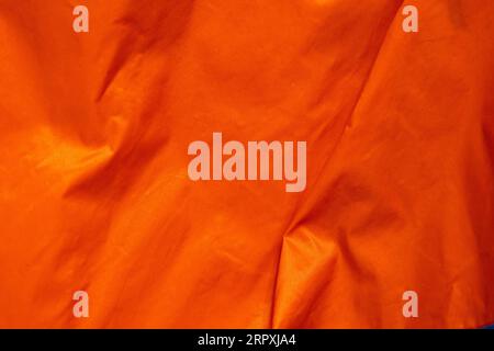 metallic orange crumpled fabric texture Stock Photo