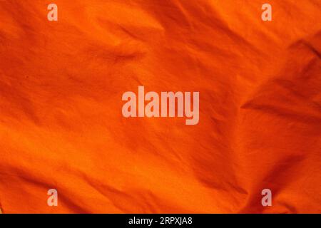 metallic orange crumpled fabric texture Stock Photo