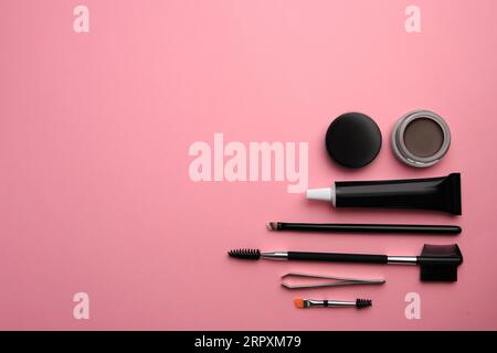 Flat lay composition with eyebrow henna and tools on pink background. Space for text Stock Photo