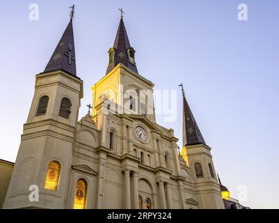 NEW ORLEANS, LA, USA - SEPTEMBER 1, 2023: Upward frontal view of St. Louis Cathedral with lights during golden hour Stock Photo