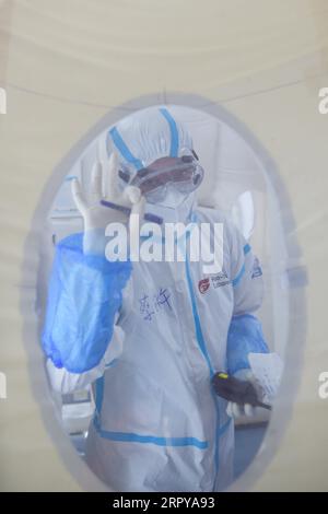 200622 -- BEIJING, June 22, 2020 -- A member of staff gestures at a COVID-19 testing lab built with an air-inflated structure in Daxing District, Beijing, capital of China, June 22, 2020. A COVID-19 testing lab built with an air-inflated structure went into trial operation on Monday at a sports venue in Daxing District of Beijing to address the city s rising demand for nucleic acid tests after a cluster of infections were confirmed recently. The mobile Huoyan Fire Eye laboratory was built in two days over the weekend to accommodate 14 automated COVID-19 testing machines provided by Chinese bio Stock Photo