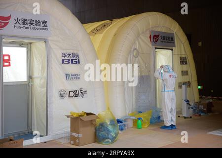 200622 -- BEIJING, June 22, 2020 -- A member of staff works at a COVID-19 testing lab built with an air-inflated structure in Daxing District, Beijing, capital of China, June 22, 2020. A COVID-19 testing lab built with an air-inflated structure went into trial operation on Monday at a sports venue in Daxing District of Beijing to address the city s rising demand for nucleic acid tests after a cluster of infections were confirmed recently. The mobile Huoyan Fire Eye laboratory was built in two days over the weekend to accommodate 14 automated COVID-19 testing machines provided by Chinese biotec Stock Photo