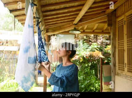 200702 -- BEIJING, July 2, 2020 -- Chen Ran dries blue dyeing works at her workshop in Qianxian County, east China s Anhui Province, June 30, 2020.  XINHUA PHOTOS OF THE DAY HanxXiaoyu PUBLICATIONxNOTxINxCHN Stock Photo