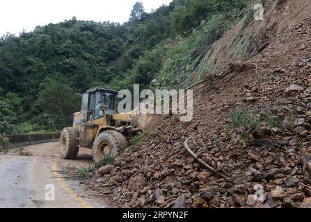 200709 -- HUANGSHAN, July 9, 2020 -- A worker cleans a road after a landslide in Chengkan Township of Huizhou District in Huangshan City, east China s Anhui Province, July 9, 2020. Heavy rainfall hit the Huizhou District of Huangshan City, leaving several villages inundated in varying degrees. The local authorities rapidly organized flood response efforts to evacuate effected residents, rehabilitate destroyed roads and dredge silt-clogged ditches.  CHINA-ANHUI-HUANGSHAN-FLOOD-RESPONSE CN HanxXiaoyu PUBLICATIONxNOTxINxCHN Stock Photo