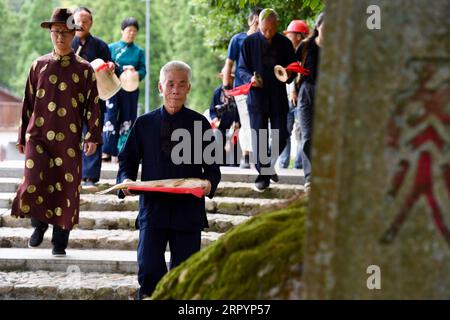 200711 -- FUZHOU, July 11, 2020 -- Villagers demonstrate a funeral ritual for deceased carp in Puyuan Village, Puyuan Township, Zhouning County, southeast China s Fujian Province, July 4, 2020. At the first glance, Puyuan Village appears no difference from other historical villages in China. But it s the carp fish in a local creek, known as the Carp Brook, that make the village special. Puyuan village covers an area of 9.2 square kilometers and has a population of about 6,200. Originated from the Ziyun Mountain, several streams converge into the 3,000-meter-long Carp Brook, with 800 meters of Stock Photo