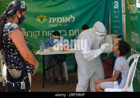 200713 -- LOD ISRAEL, July 13, 2020 Xinhua -- A medical worker collects a swab from a boy for a COVID-19 test in Lod, central Israel, on July 13, 2020. Israel s Ministry of Health has reported 1,962 new coronavirus cases on Monday, bringing the total cases to 40,632. Photo by Gil Cohen Magen/Xinhua ISRAEL-LOD-COVID-19-CASES PUBLICATIONxNOTxINxCHN Stock Photo
