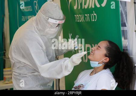 200713 -- LOD ISRAEL, July 13, 2020 Xinhua -- A medical worker collects a swab from a girl for a COVID-19 test in Lod, central Israel, on July 13, 2020. Israel s Ministry of Health has reported 1,962 new coronavirus cases on Monday, bringing the total cases to 40,632. Photo by Gil Cohen Magen/Xinhua ISRAEL-LOD-COVID-19-CASES PUBLICATIONxNOTxINxCHN Stock Photo
