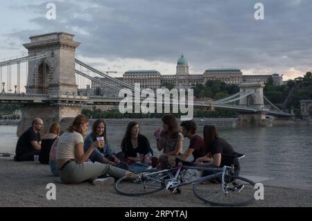 200715 -- BUDAPEST, July 15, 2020 -- People spend their leisure time on the bank of the Danube River after the COVID-19 restrictions were lifted in downtown Budapest, Hungary, on July 14, 2020. Photo by /Xinhua HUNGARY-BUDAPEST-COVID-19-DAILY LIFE AttilaxVolgyi PUBLICATIONxNOTxINxCHN Stock Photo